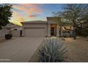 Charming single-story home featuring a desert landscape and a two-car garage at 16155 E Glenview Pl, Fountain Hills, AZ 85268