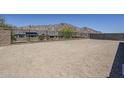 Large backyard featuring block wall and wrought iron fencing offering mountain views at 21450 W Meadowbrook Ave, Buckeye, AZ 85396