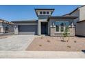 Charming single-Gathering home featuring modern architectural details, a two-car garage and desert landscaping at 21450 W Meadowbrook Ave, Buckeye, AZ 85396