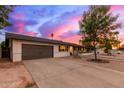 Charming single-story home with an attached garage, landscaped front yard, mature tree, and a concrete driveway at 2221 W De Palma Cir, Mesa, AZ 85202