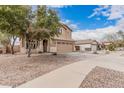 Charming home with well-kept landscaping, a spacious driveway, and a two-car garage at 22337 E Via Del Palo --, Queen Creek, AZ 85142