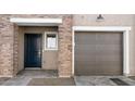 A well-maintained facade with a garage, front door, and brick accents at 2823 W Eagle Talon Rd, Phoenix, AZ 85085
