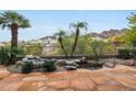 Beautiful backyard featuring desert landscaping, a pond, and a mountain view at 3120 E Squaw Peak Cir, Phoenix, AZ 85016