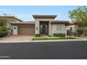 Charming single-story home featuring desert landscaping, a two car garage, and a covered front entrance at 3120 E Squaw Peak Cir, Phoenix, AZ 85016