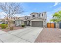 Neutral color scheme two-story home with a driveway, beautiful landscaping, and a two-car garage at 3555 E Gary Way, Gilbert, AZ 85234