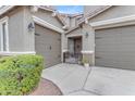 Close-up view of the front entrance featuring a double garage and decorative gate at 3555 E Gary Way, Gilbert, AZ 85234