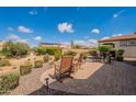 Charming backyard patio with seating and landscaping, ideal for relaxing outdoors and enjoying the views at 37036 N Stoneware Dr, Queen Creek, AZ 85140