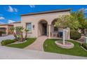 Charming front exterior with stucco, well-manicured landscaping, and a welcoming covered entrance at 37036 N Stoneware Dr, Queen Creek, AZ 85140