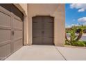 Close-up of the home's two-car garage doors, showcasing their attractive design and curb appeal at 37036 N Stoneware Dr, Queen Creek, AZ 85140