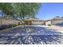 Charming home with desert landscaping, a covered porch, and an American flag at 4369 E Coal St, San Tan Valley, AZ 85143