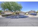 Inviting single-Gathering home with mature landscaping, a covered front porch, and a two-car garage at 4369 E Coal St, San Tan Valley, AZ 85143