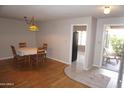 Cozy dining area featuring hardwood flooring, table, and access to patio at 4773 E Hopi St, Phoenix, AZ 85044