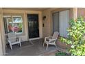 Covered front porch with brick detail and two chairs for relaxing in the shade at 4773 E Hopi St, Phoenix, AZ 85044