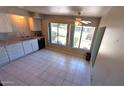 Eat-in kitchen features white cabinetry, tiled floors, and lots of natural light at 4773 E Hopi St, Phoenix, AZ 85044