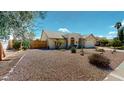 Well-maintained home with low maintenance desert landscaping and an attached two-car garage at 4903 E Halifax St, Mesa, AZ 85205