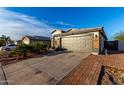 Suburban home featuring a two car garage, desert landscaping and neutral color palette at 5361 N 77Th Ln, Glendale, AZ 85303