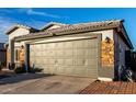 A close up of the two car garage showing brick detail and neutral color palette at 5361 N 77Th Ln, Glendale, AZ 85303