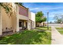 Exterior view of townhomes featuring well maintained lawns and walkways at 5741 N 44Th Ln, Glendale, AZ 85301