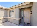 Close-up of a well-maintained front porch with neutral colors, a window, and an inviting front door at 6615 S 25Th Dr, Phoenix, AZ 85041