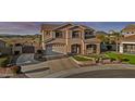 Attractive two-story home featuring a two-car garage, well-manicured front lawn, and covered porch at 7628 W Donald Dr, Peoria, AZ 85383