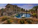 Relaxing backyard pool with mature tropical landscaping, and a patio area perfect for outdoor entertaining at 7628 W Donald Dr, Peoria, AZ 85383
