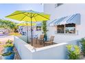 Relaxing patio area with chairs, table, and umbrellas, perfect for outdoor enjoyment at 7732 E Coolidge St, Scottsdale, AZ 85251