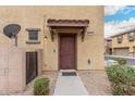 Charming townhome featuring a covered entrance, walkway, and desert landscaping at 8105 W Groom Creek Rd, Phoenix, AZ 85043