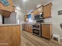 Well-equipped kitchen features wood cabinets, modern stainless steel appliances, and tile countertops at 8700 E University Dr # 953, Mesa, AZ 85207