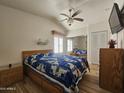 Comfortable bedroom with a ceiling fan, large bed, and mirrored closet doors at 8700 E University Dr # 953, Mesa, AZ 85207