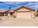 View of home's exterior showing desert landscaping and a two-car garage at 9136 W Sequoia Dr, Peoria, AZ 85382