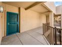 Condo exterior with secure teal door and railing to upper floors of the community at 14950 W Mountain View Blvd # 5312, Surprise, AZ 85374