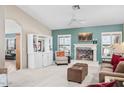 Cozy living room featuring a fireplace, vaulted ceilings, and built-in shelving at 15546 W Whitton Ave, Goodyear, AZ 85395