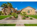 Charming single-story home featuring meticulously landscaped yard, walkway, and inviting front entrance at 17936 E Colt Ct, Queen Creek, AZ 85142