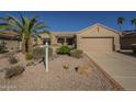 This charming single-story home boasts a well-maintained desert landscape with a two-car garage at 19746 N Wind Rose Way, Surprise, AZ 85374