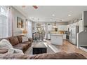 Open-concept living room flows into the kitchen and dining area, featuring modern finishes at 2727 N Price Rd # 26, Chandler, AZ 85224