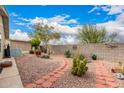 Beautiful backyard featuring desert landscaping, a brick-lined walkway and block wall providing a private outdoor space at 3301 S Goldfield Rd # 2105, Apache Junction, AZ 85119