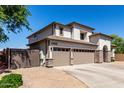 Attractive two-story home with a three-car garage, desert landscaping and private entry at 34990 N Spur Cir, San Tan Valley, AZ 85144