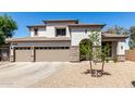 Attractive two-story home with a three-car garage and drought tolerant landscaping at 34990 N Spur Cir, San Tan Valley, AZ 85144
