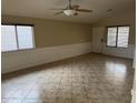 Inviting living room with tile flooring, decorative trim, and bright windows at 43818 W Arizona Ave, Maricopa, AZ 85138