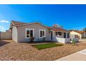 A cozy home featuring manicured gravel landscaping with pops of green and a well-lit facade at 4449 W Turquoise Ave, Glendale, AZ 85302