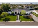 Aerial view of a stunning single-story home with manicured lawn and mature trees in a desirable neighborhood at 6455 E Calle Del Media --, Scottsdale, AZ 85251