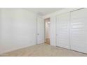 Well-lit bedroom features clean white walls, carpet, closet, and bright white doors at 7436 W Buckhorn Trl, Peoria, AZ 85383