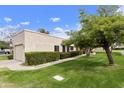 Charming single-story home with lush green lawn and mature trees, offering a serene outdoor space at 755 S Arrowwood Way, Mesa, AZ 85208