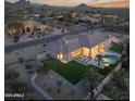 Expansive single-Gathering home featuring a large backyard with a pool, putting green, and mountain views at 9826 N 131St St, Scottsdale, AZ 85259