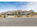 Charming single-story home with desert landscaping, circular driveway, and arched windows at 9826 N 131St St, Scottsdale, AZ 85259