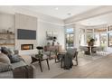 Inviting living room features modern fireplace, tv, comfortable seating, and access to a dining area at 9826 N 131St St, Scottsdale, AZ 85259