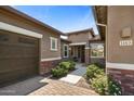 A front view of a single story home with a well maintained front yard and brick accents on the columns at 1163 E Holbrook St, Gilbert, AZ 85298