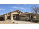 Charming single-story home features a well-manicured lawn and attached two-car garage at 11669 N 165Th Ave, Surprise, AZ 85388