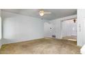 Bright living room with neutral carpet, white walls, and ceiling fan at 1816 N Salem St, Mesa, AZ 85205