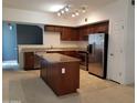 Spacious kitchen featuring granite countertops, stainless steel appliances, a kitchen island, and tile flooring at 1920 E Bell Rd # 1073, Phoenix, AZ 85022